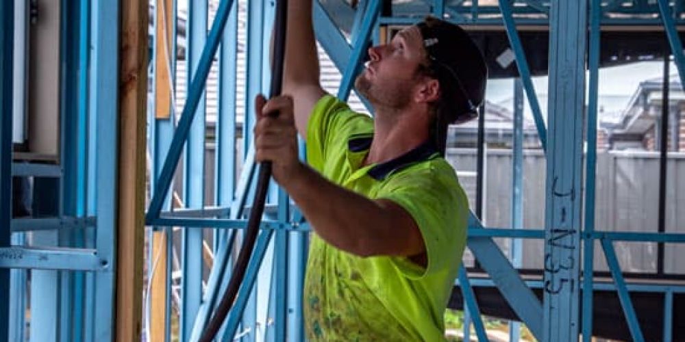 Plumber working under an elevated home